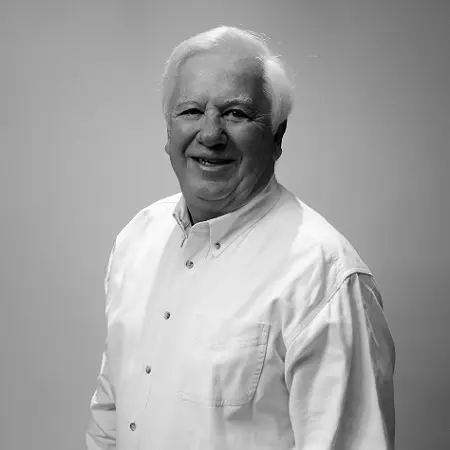 A man with white hair and wearing a shirt.