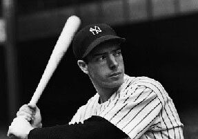 A baseball player holding a bat in his hands.