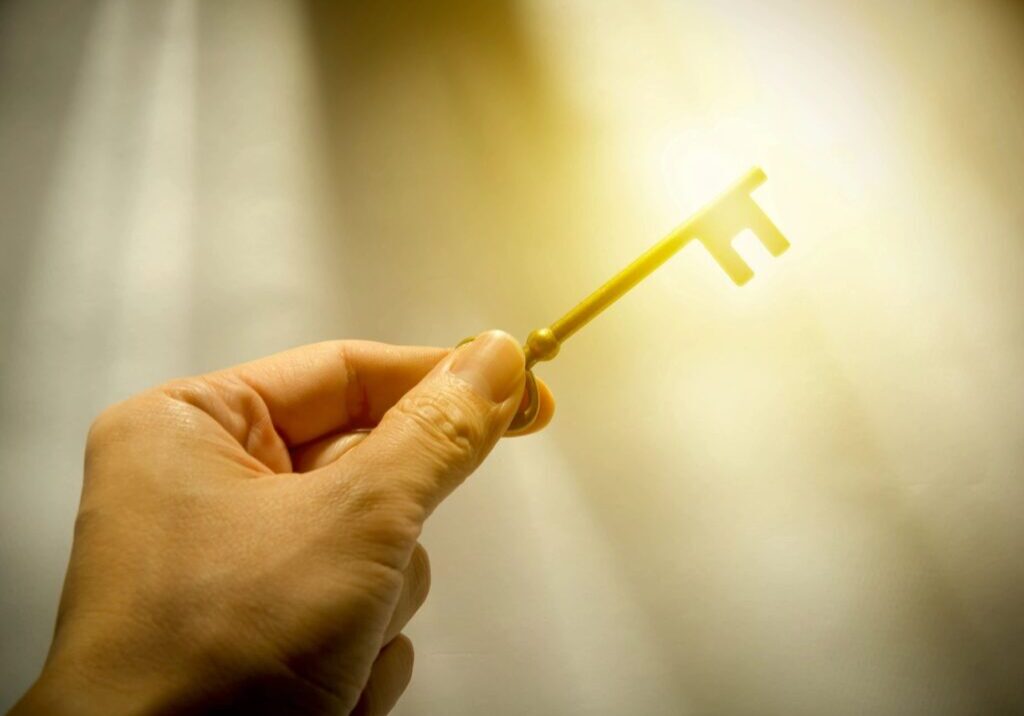 A person holding a key in their hand.