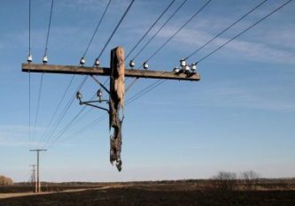 A power line with many wires hanging from it.